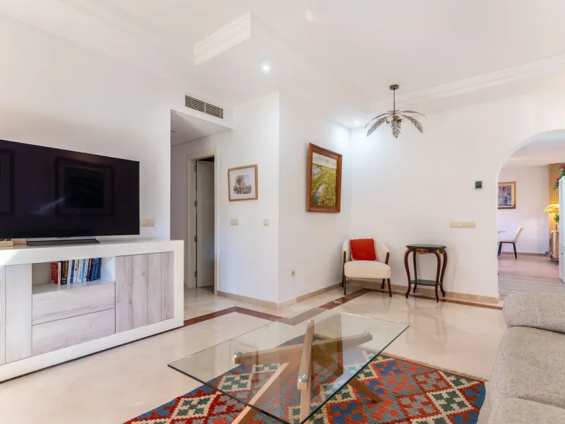 An apartment with 3 bedrooms, 2 bathrooms, a spacious living room, and a new kitchen with a dining area overlooking a beautiful garden with a fountain. The property is located in a unique, lush residential community where the views from the terrace and wi