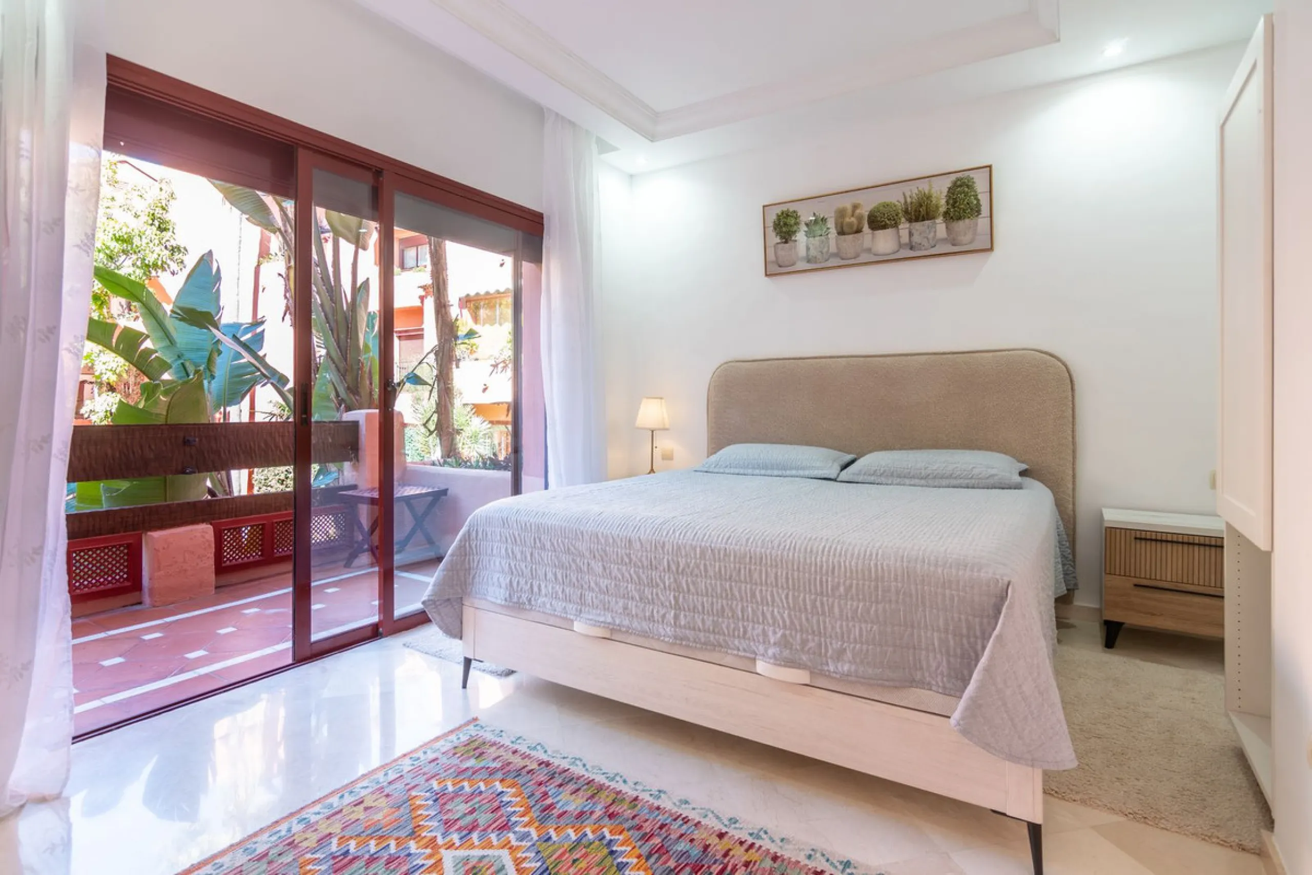 An apartment with 3 bedrooms, 2 bathrooms, a spacious living room, and a new kitchen with a dining area overlooking a beautiful garden with a fountain. The property is located in a unique, lush residential community where the views from the terrace and wi