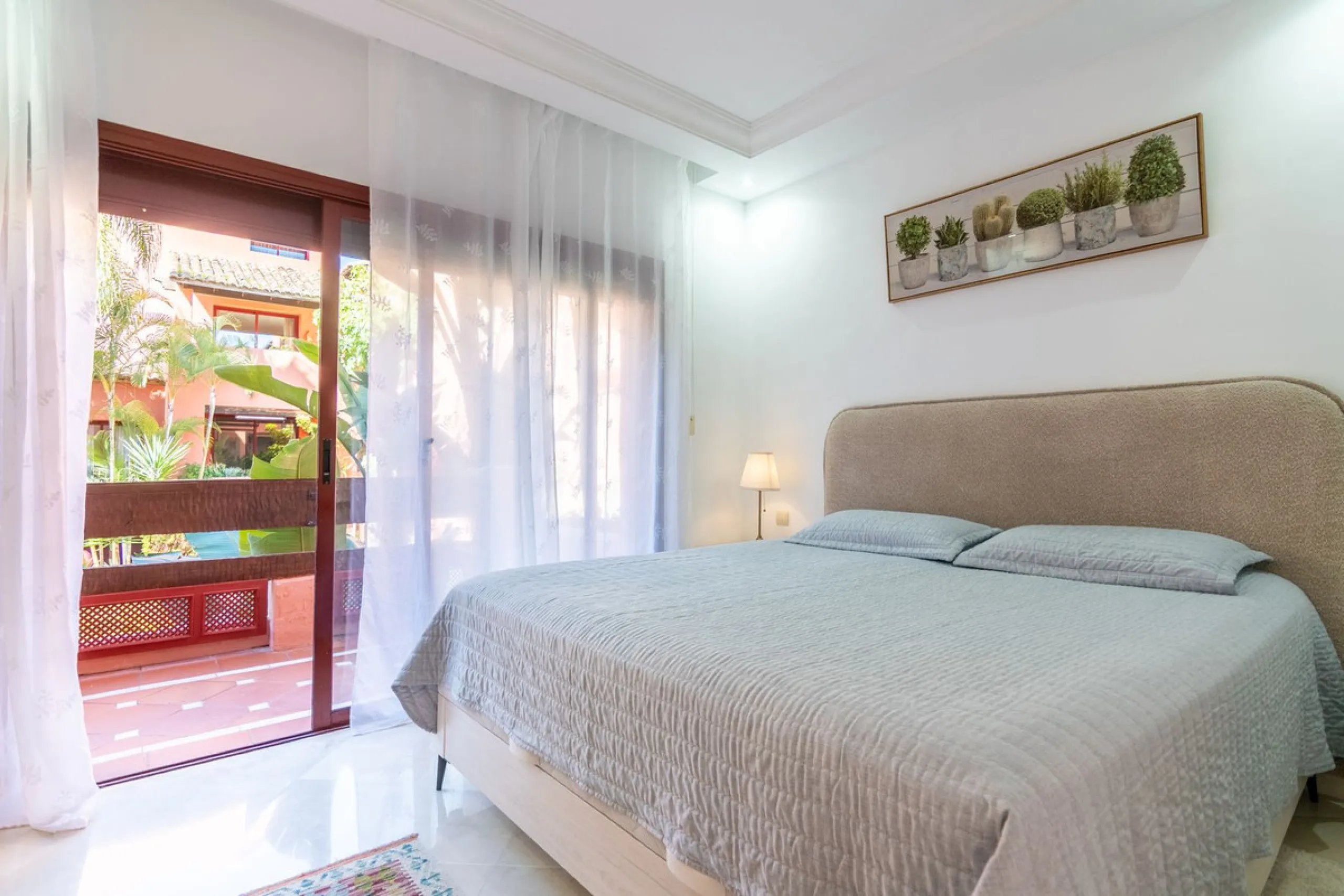 An apartment with 3 bedrooms, 2 bathrooms, a spacious living room, and a new kitchen with a dining area overlooking a beautiful garden with a fountain. The property is located in a unique, lush residential community where the views from the terrace and wi