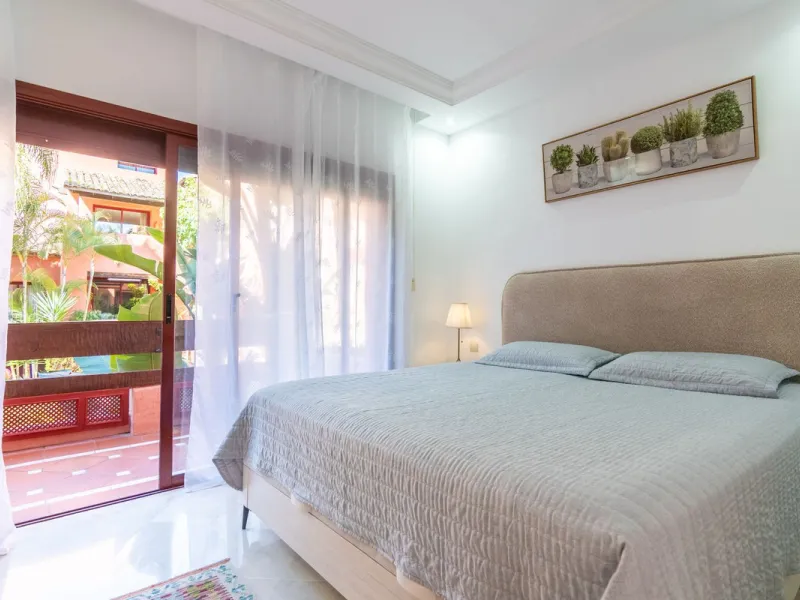 An apartment with 3 bedrooms, 2 bathrooms, a spacious living room, and a new kitchen with a dining area overlooking a beautiful garden with a fountain. The property is located in a unique, lush residential community where the views from the terrace and wi