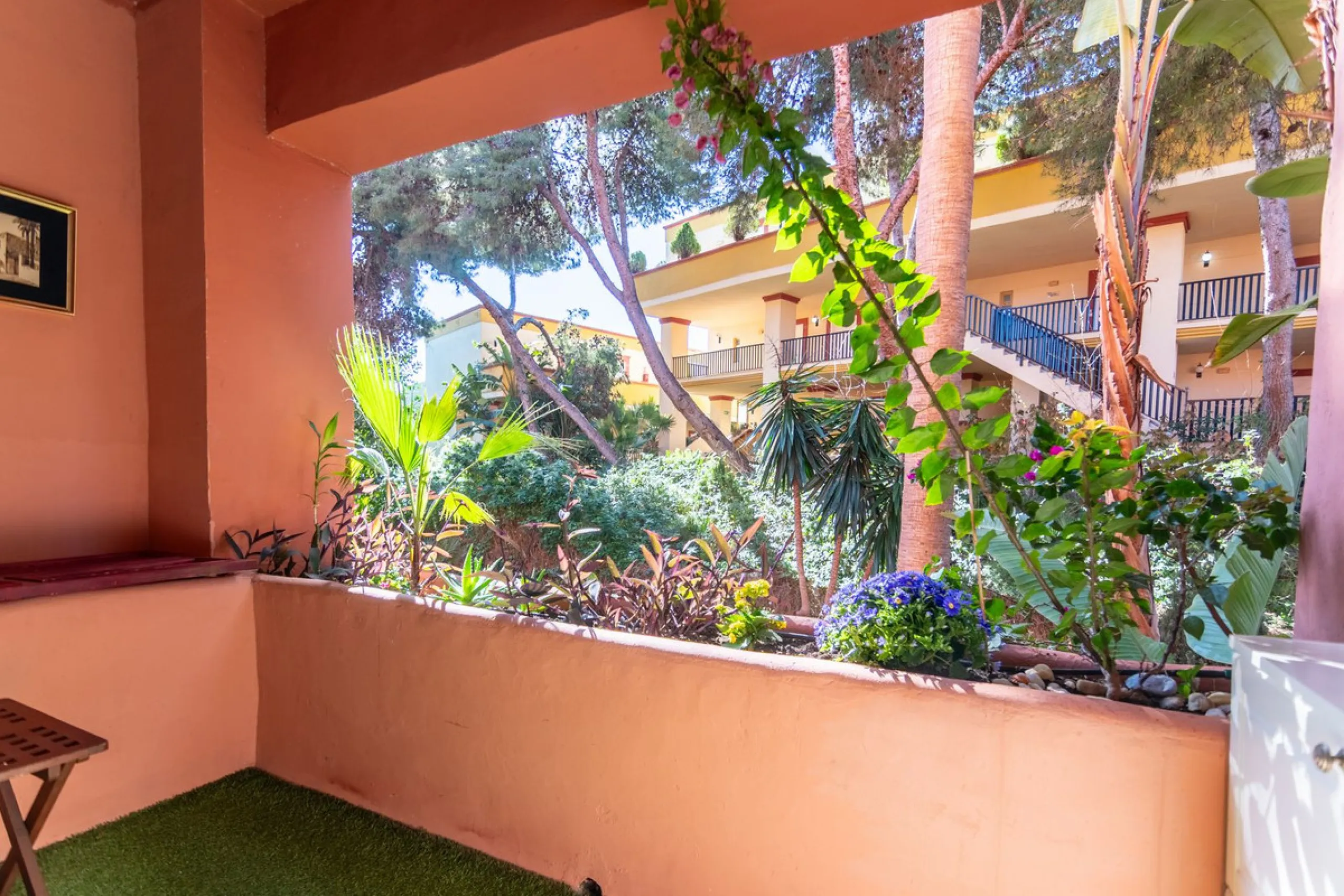 An apartment with 3 bedrooms, 2 bathrooms, a spacious living room, and a new kitchen with a dining area overlooking a beautiful garden with a fountain. The property is located in a unique, lush residential community where the views from the terrace and wi