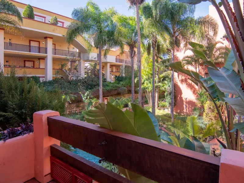 An apartment with 3 bedrooms, 2 bathrooms, a spacious living room, and a new kitchen with a dining area overlooking a beautiful garden with a fountain. The property is located in a unique, lush residential community where the views from the terrace and wi
