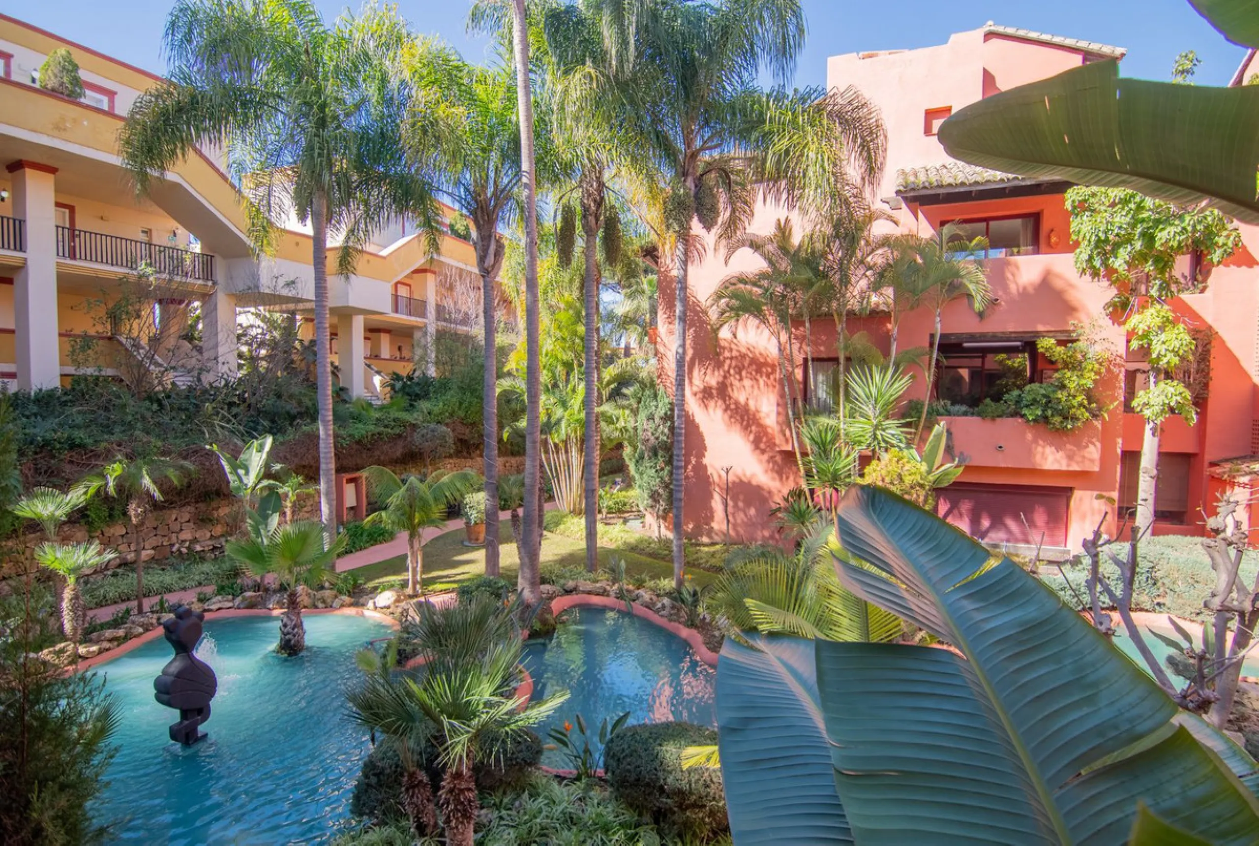An apartment with 3 bedrooms, 2 bathrooms, a spacious living room, and a new kitchen with a dining area overlooking a beautiful garden with a fountain. The property is located in a unique, lush residential community where the views from the terrace and wi