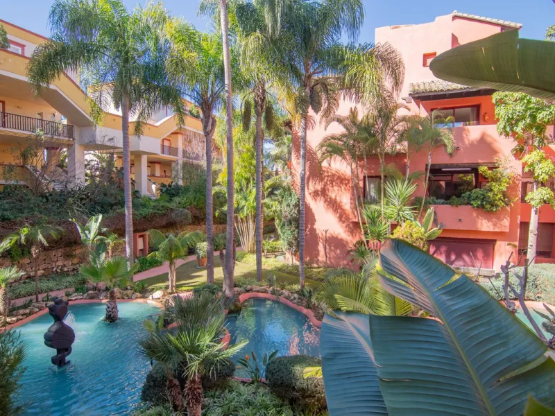 An apartment with 3 bedrooms, 2 bathrooms, a spacious living room, and a new kitchen with a dining area overlooking a beautiful garden with a fountain. The property is located in a unique, lush residential community where the views from the terrace and wi