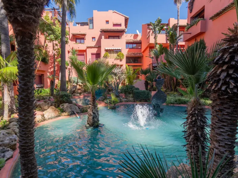 An apartment with 3 bedrooms, 2 bathrooms, a spacious living room, and a new kitchen with a dining area overlooking a beautiful garden with a fountain. The property is located in a unique, lush residential community where the views from the terrace and wi