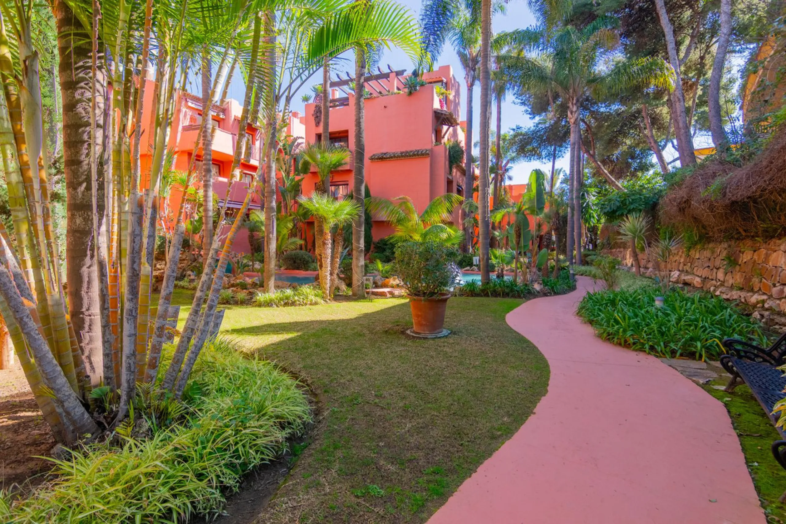 An apartment with 3 bedrooms, 2 bathrooms, a spacious living room, and a new kitchen with a dining area overlooking a beautiful garden with a fountain. The property is located in a unique, lush residential community where the views from the terrace and wi