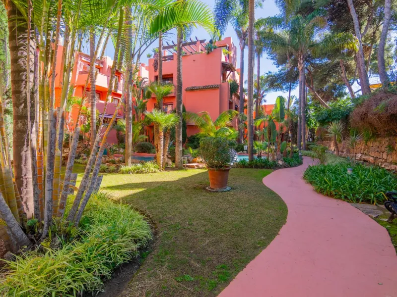 An apartment with 3 bedrooms, 2 bathrooms, a spacious living room, and a new kitchen with a dining area overlooking a beautiful garden with a fountain. The property is located in a unique, lush residential community where the views from the terrace and wi