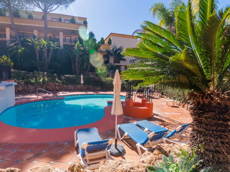An apartment with 3 bedrooms, 2 bathrooms, a spacious living room, and a new kitchen with a dining area overlooking a beautiful garden with a fountain. The property is located in a unique, lush residential community where the views from the terrace and wi