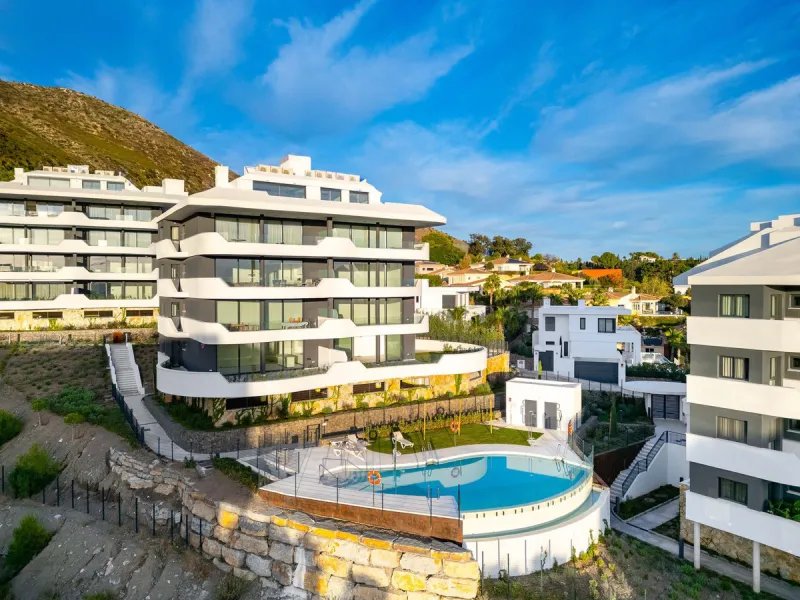 Welcome to a beautifully positioned southwest-facing garden apartment in the heart of Higuerón — a home that offers both privacy and extraordinary views. Located on the eastern corner of the building, this residence is one of only two ground-floor apartme