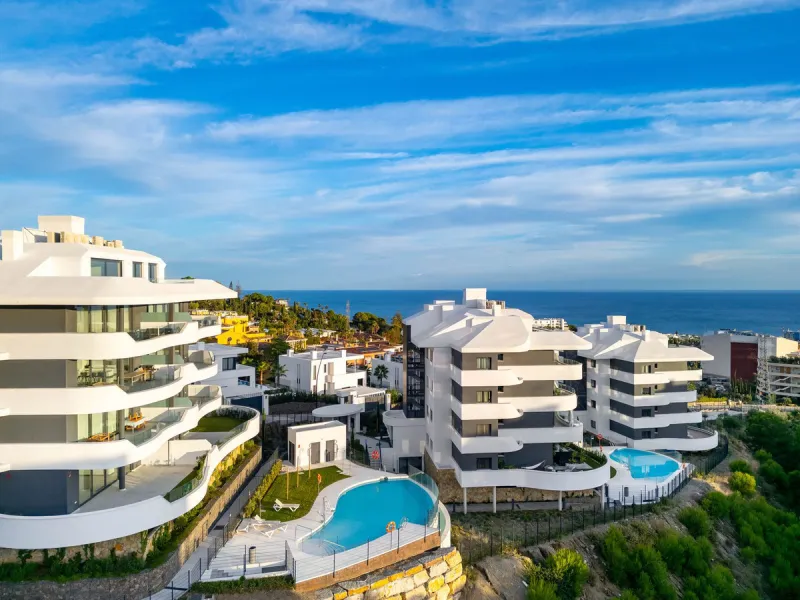 Welcome to a beautifully positioned southwest-facing garden apartment in the heart of Higuerón — a home that offers both privacy and extraordinary views. Located on the eastern corner of the building, this residence is one of only two ground-floor apartme
