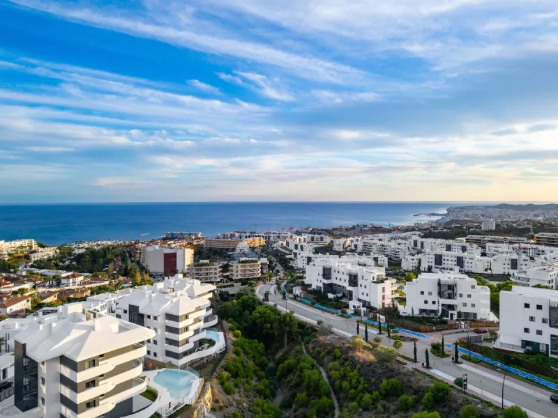 Welcome to a beautifully positioned southwest-facing garden apartment in the heart of Higuerón — a home that offers both privacy and extraordinary views. Located on the eastern corner of the building, this residence is one of only two ground-floor apartme