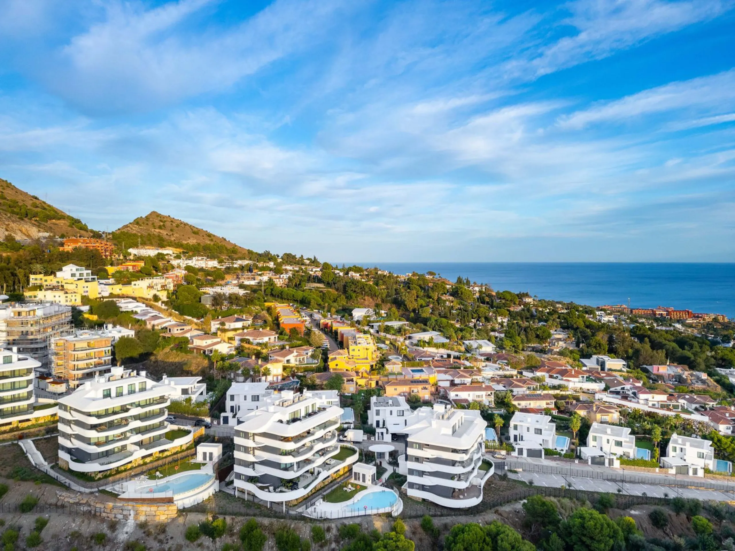 Welcome to a beautifully positioned southwest-facing garden apartment in the heart of Higuerón — a home that offers both privacy and extraordinary views. Located on the eastern corner of the building, this residence is one of only two ground-floor apartme