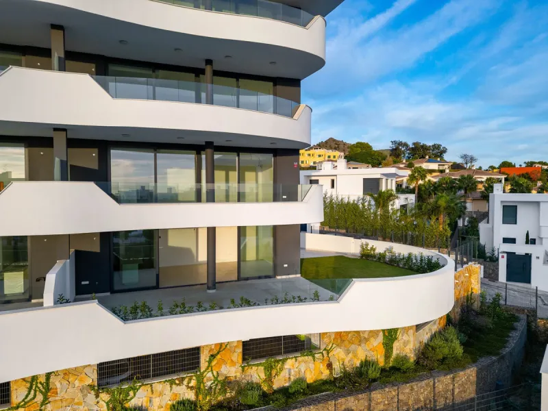 Welcome to a beautifully positioned southwest-facing garden apartment in the heart of Higuerón — a home that offers both privacy and extraordinary views. Located on the eastern corner of the building, this residence is one of only two ground-floor apartme
