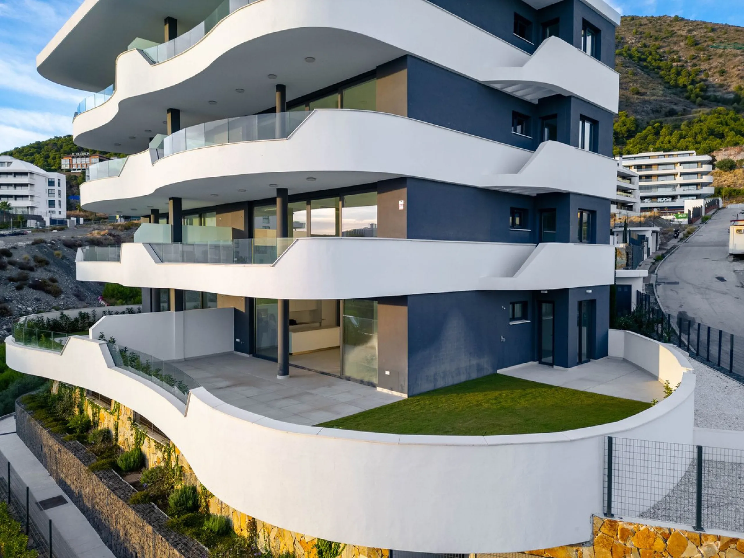 Welcome to a beautifully positioned southwest-facing garden apartment in the heart of Higuerón — a home that offers both privacy and extraordinary views. Located on the eastern corner of the building, this residence is one of only two ground-floor apartme