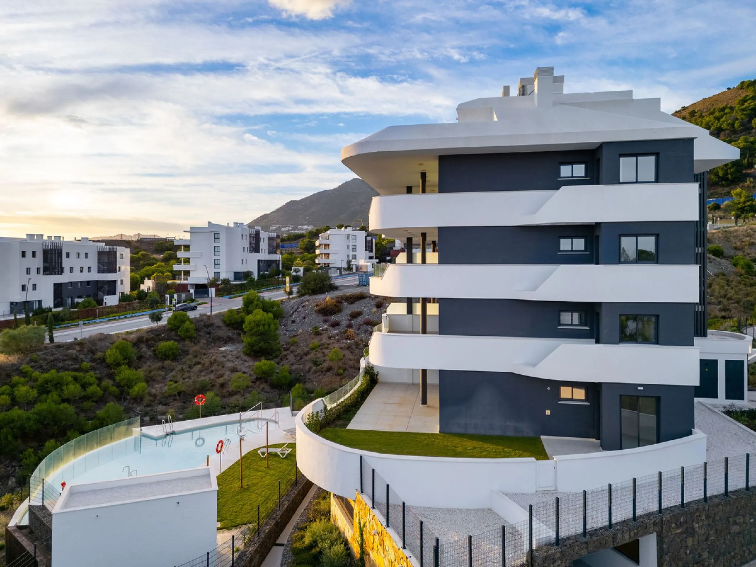Welcome to a beautifully positioned southwest-facing garden apartment in the heart of Higuerón — a home that offers both privacy and extraordinary views. Located on the eastern corner of the building, this residence is one of only two ground-floor apartme