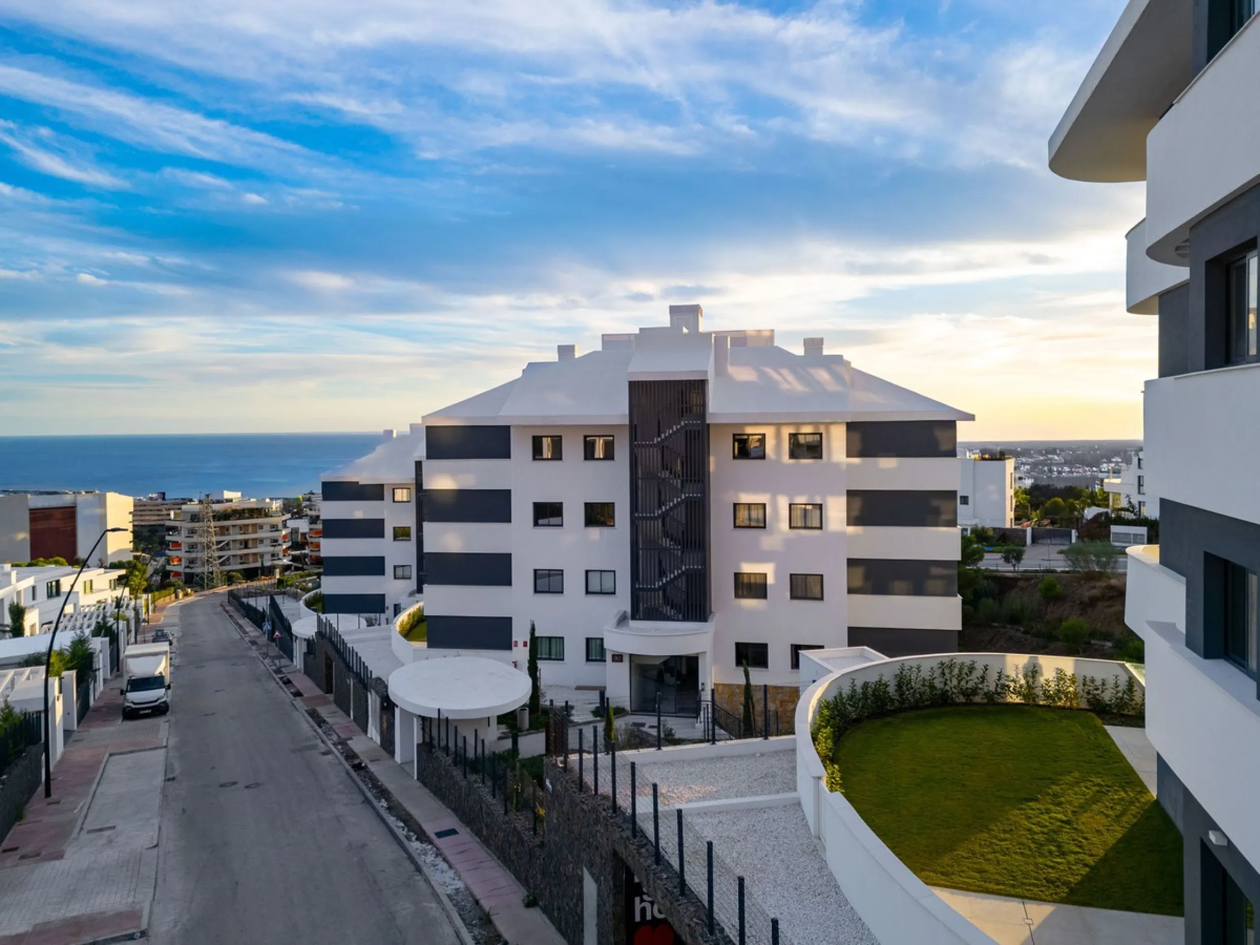Welcome to a beautifully positioned southwest-facing garden apartment in the heart of Higuerón — a home that offers both privacy and extraordinary views. Located on the eastern corner of the building, this residence is one of only two ground-floor apartme