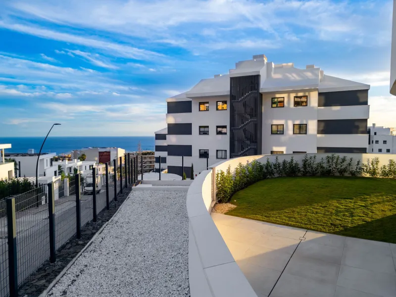 Welcome to a beautifully positioned southwest-facing garden apartment in the heart of Higuerón — a home that offers both privacy and extraordinary views. Located on the eastern corner of the building, this residence is one of only two ground-floor apartme