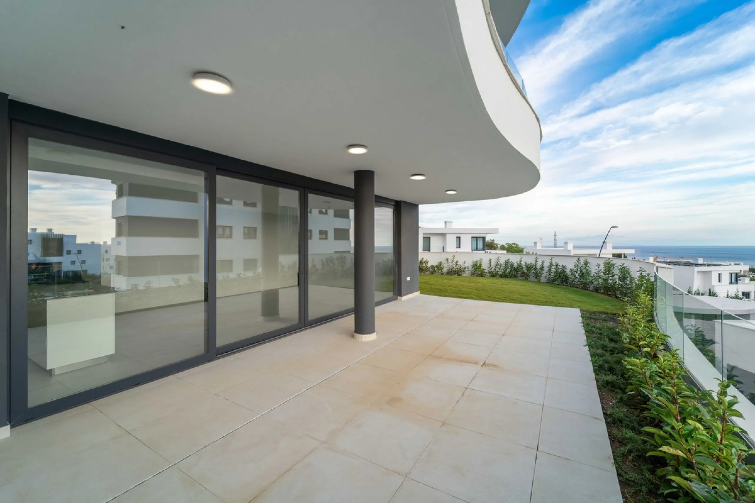 Welcome to a beautifully positioned southwest-facing garden apartment in the heart of Higuerón — a home that offers both privacy and extraordinary views. Located on the eastern corner of the building, this residence is one of only two ground-floor apartme