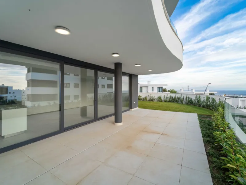 Welcome to a beautifully positioned southwest-facing garden apartment in the heart of Higuerón — a home that offers both privacy and extraordinary views. Located on the eastern corner of the building, this residence is one of only two ground-floor apartme