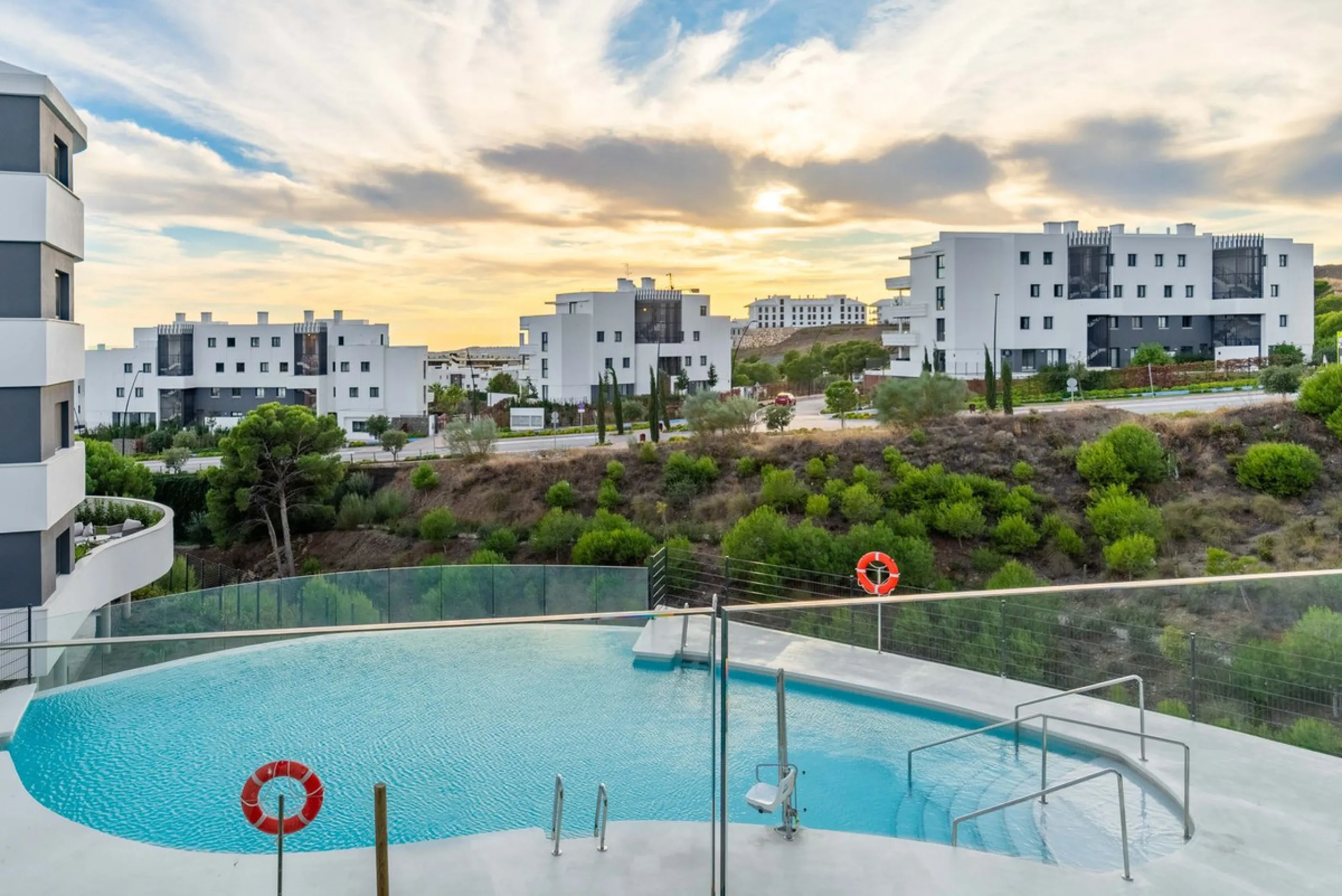 Welcome to a beautifully positioned southwest-facing garden apartment in the heart of Higuerón — a home that offers both privacy and extraordinary views. Located on the eastern corner of the building, this residence is one of only two ground-floor apartme