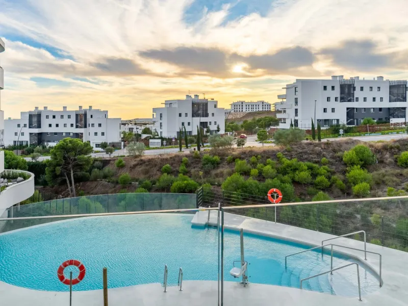 Welcome to a beautifully positioned southwest-facing garden apartment in the heart of Higuerón — a home that offers both privacy and extraordinary views. Located on the eastern corner of the building, this residence is one of only two ground-floor apartme
