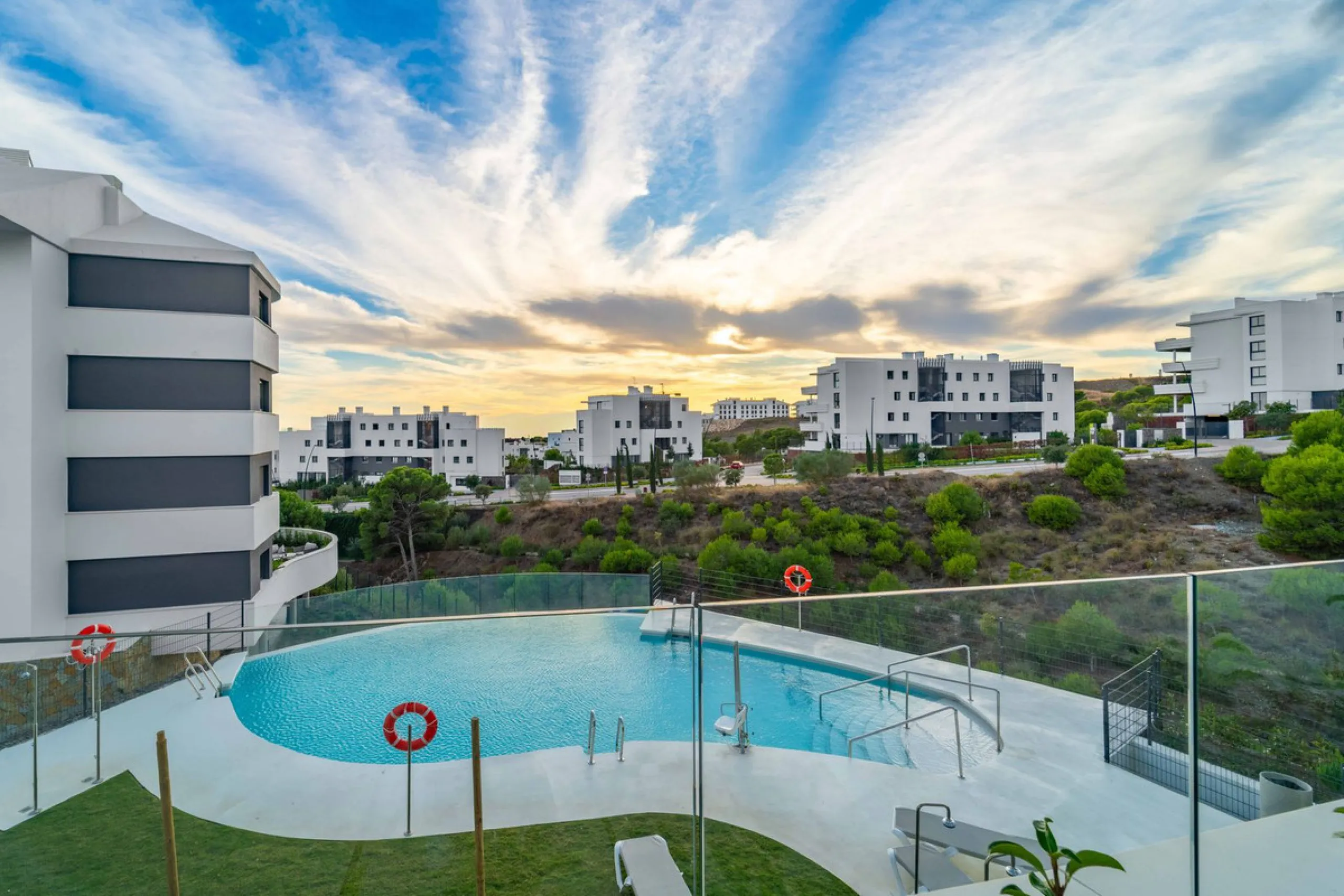 Welcome to a beautifully positioned southwest-facing garden apartment in the heart of Higuerón — a home that offers both privacy and extraordinary views. Located on the eastern corner of the building, this residence is one of only two ground-floor apartme