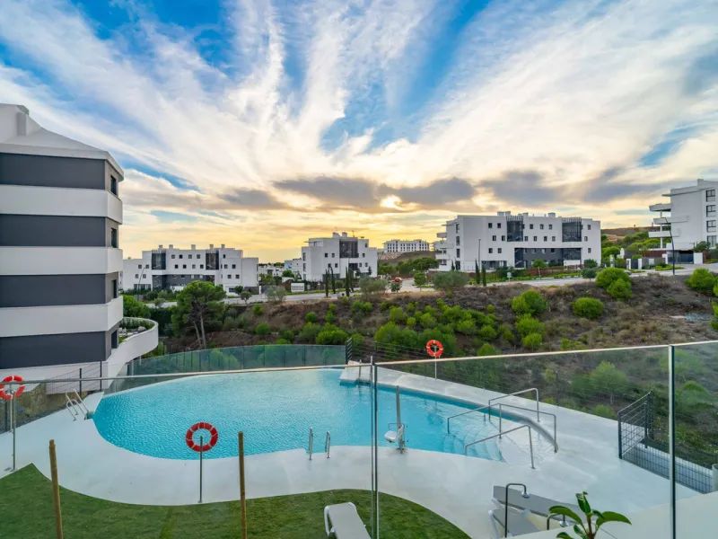 Welcome to a beautifully positioned southwest-facing garden apartment in the heart of Higuerón — a home that offers both privacy and extraordinary views. Located on the eastern corner of the building, this residence is one of only two ground-floor apartme