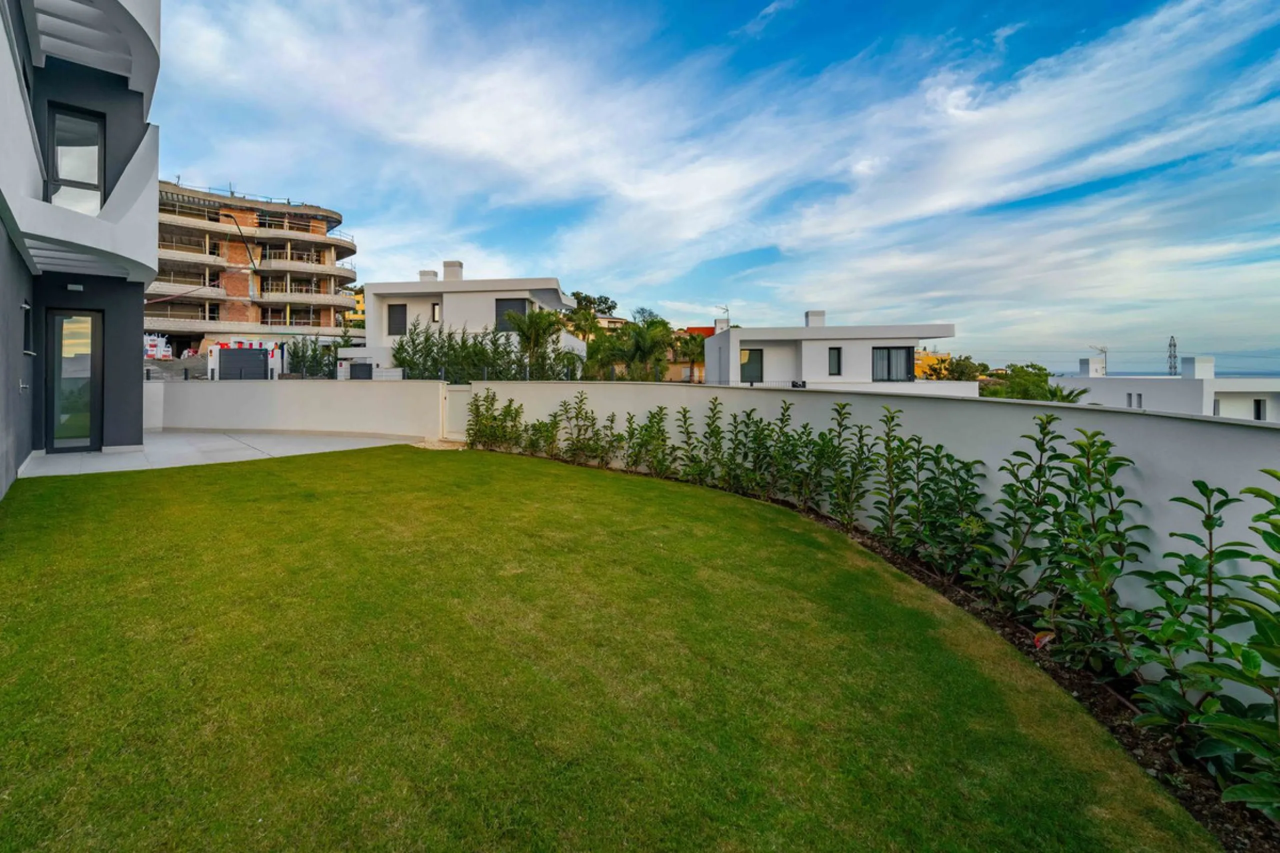 Welcome to a beautifully positioned southwest-facing garden apartment in the heart of Higuerón — a home that offers both privacy and extraordinary views. Located on the eastern corner of the building, this residence is one of only two ground-floor apartme