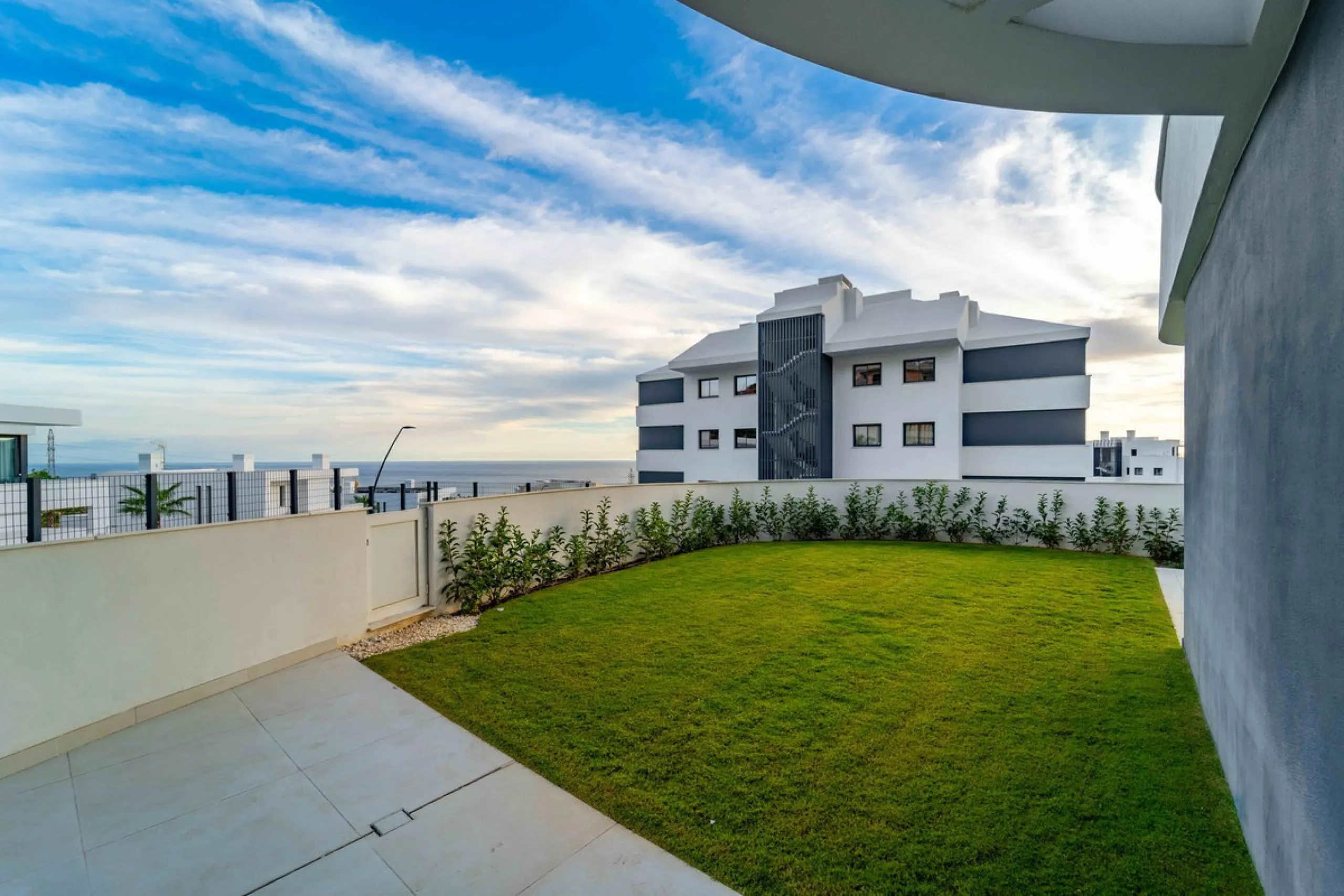 Welcome to a beautifully positioned southwest-facing garden apartment in the heart of Higuerón — a home that offers both privacy and extraordinary views. Located on the eastern corner of the building, this residence is one of only two ground-floor apartme