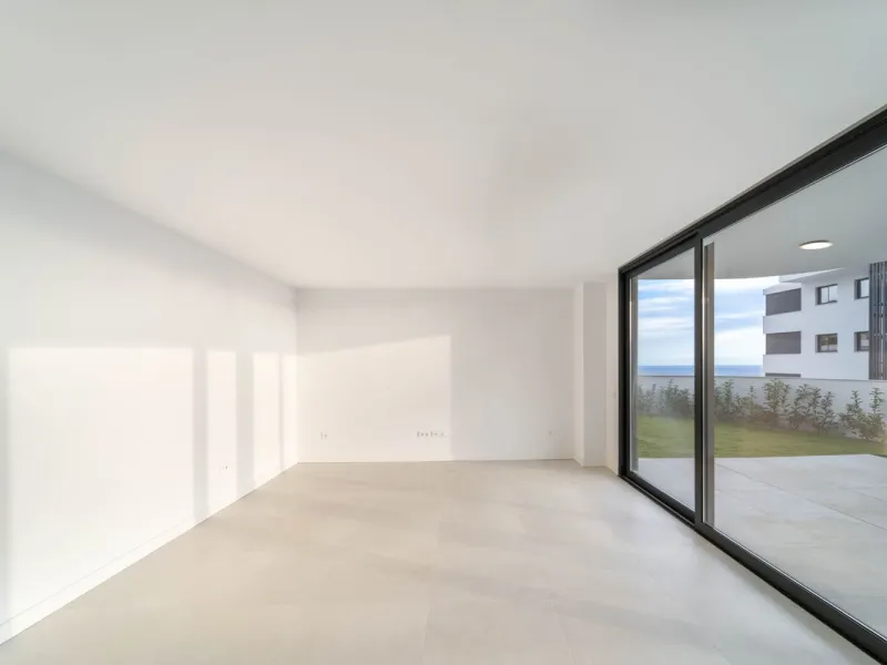 Welcome to a beautifully positioned southwest-facing garden apartment in the heart of Higuerón — a home that offers both privacy and extraordinary views. Located on the eastern corner of the building, this residence is one of only two ground-floor apartme