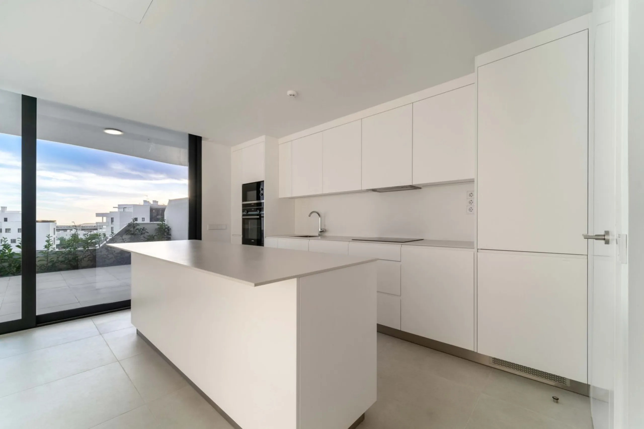 Welcome to a beautifully positioned southwest-facing garden apartment in the heart of Higuerón — a home that offers both privacy and extraordinary views. Located on the eastern corner of the building, this residence is one of only two ground-floor apartme