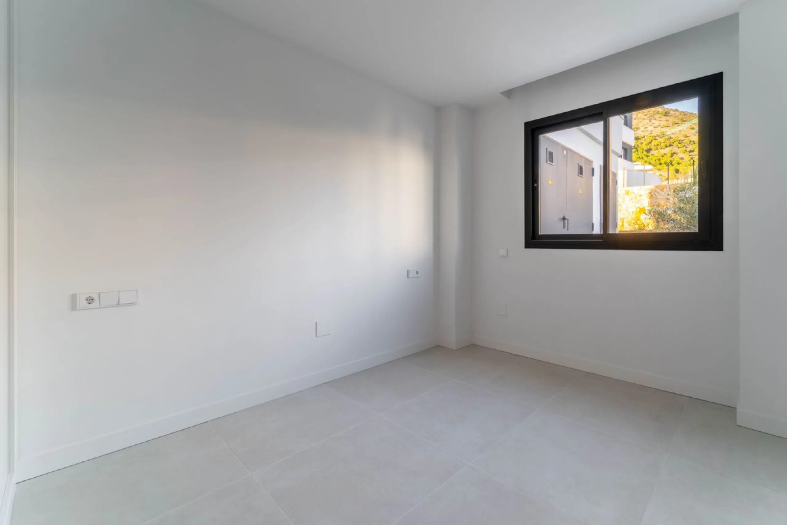 Welcome to a beautifully positioned southwest-facing garden apartment in the heart of Higuerón — a home that offers both privacy and extraordinary views. Located on the eastern corner of the building, this residence is one of only two ground-floor apartme