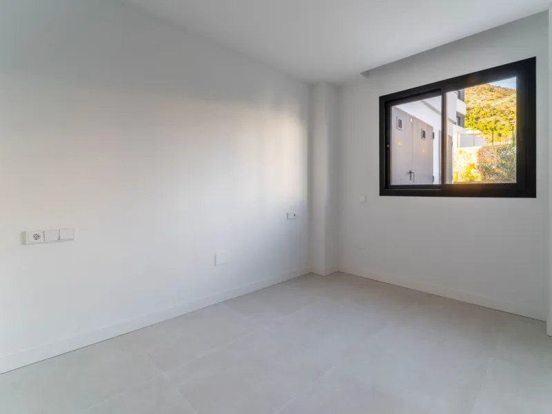 Welcome to a beautifully positioned southwest-facing garden apartment in the heart of Higuerón — a home that offers both privacy and extraordinary views. Located on the eastern corner of the building, this residence is one of only two ground-floor apartme