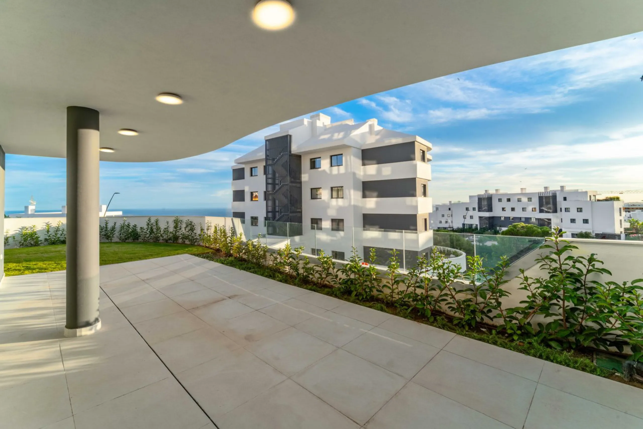 Welcome to a beautifully positioned southwest-facing garden apartment in the heart of Higuerón — a home that offers both privacy and extraordinary views. Located on the eastern corner of the building, this residence is one of only two ground-floor apartme