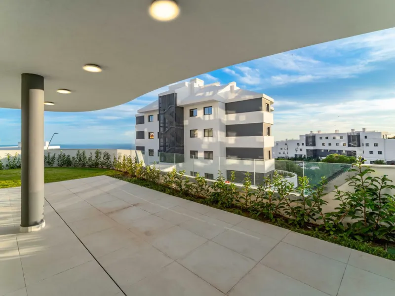Welcome to a beautifully positioned southwest-facing garden apartment in the heart of Higuerón — a home that offers both privacy and extraordinary views. Located on the eastern corner of the building, this residence is one of only two ground-floor apartme