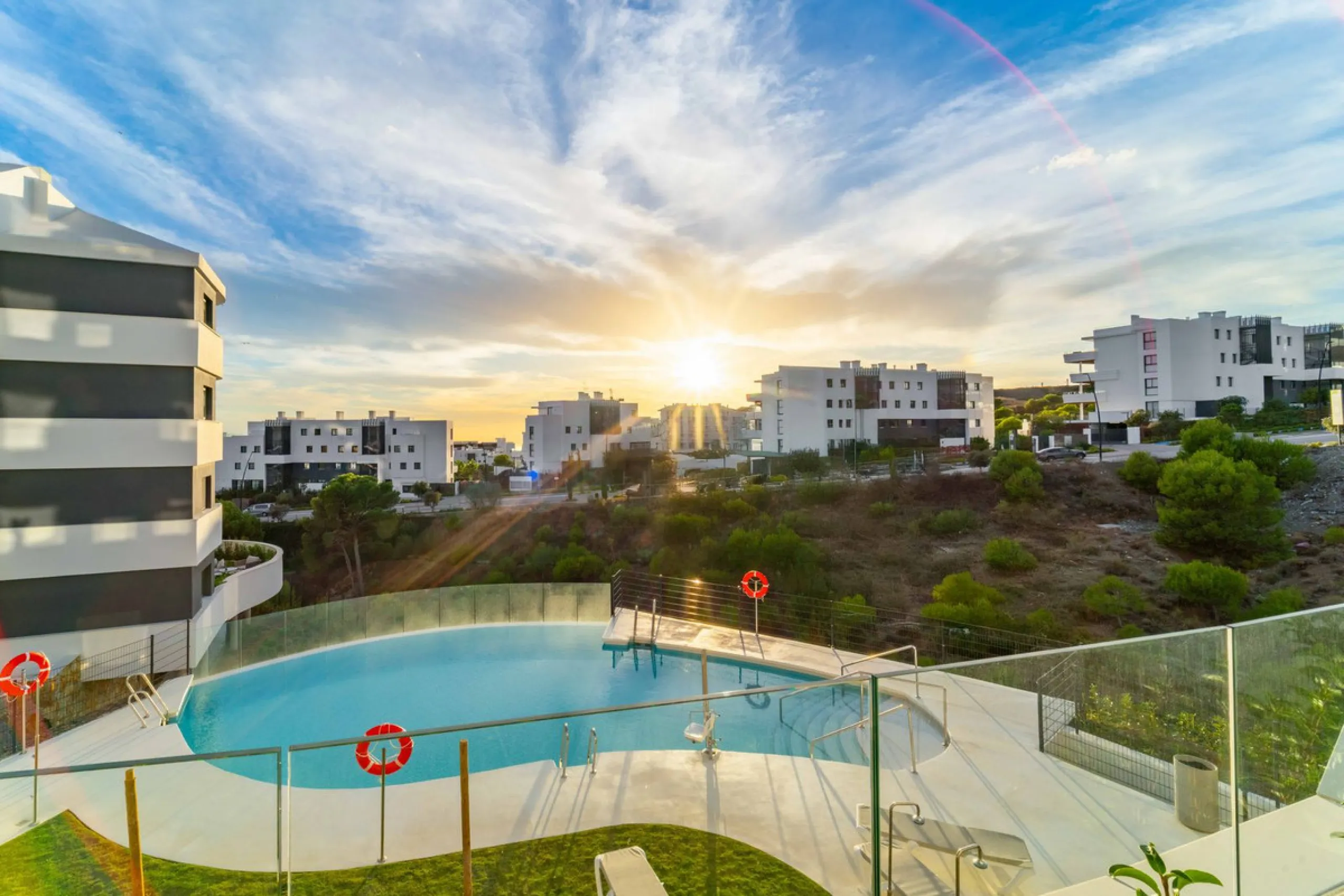 Welcome to a beautifully positioned southwest-facing garden apartment in the heart of Higuerón — a home that offers both privacy and extraordinary views. Located on the eastern corner of the building, this residence is one of only two ground-floor apartme