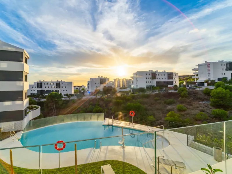 Welcome to a beautifully positioned southwest-facing garden apartment in the heart of Higuerón — a home that offers both privacy and extraordinary views. Located on the eastern corner of the building, this residence is one of only two ground-floor apartme
