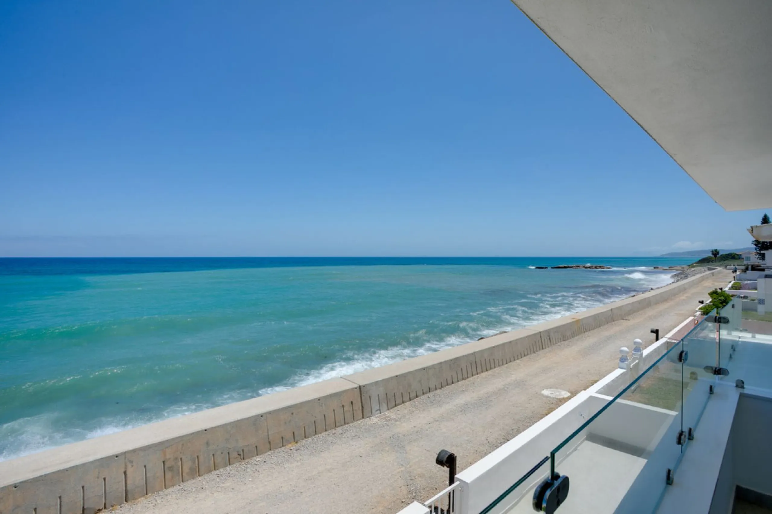 A beautifully renovated beachfront villa with perfect sea views. The house has been tastefully modernised to offer a large open plan living room with fully fitted modern kitchen, on the lower level is also one of the 3 bedrooms with bathroom.