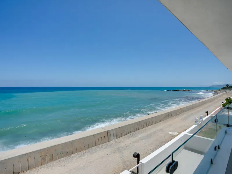 A beautifully renovated beachfront villa with perfect sea views. The house has been tastefully modernised to offer a large open plan living room with fully fitted modern kitchen, on the lower level is also one of the 3 bedrooms with bathroom.