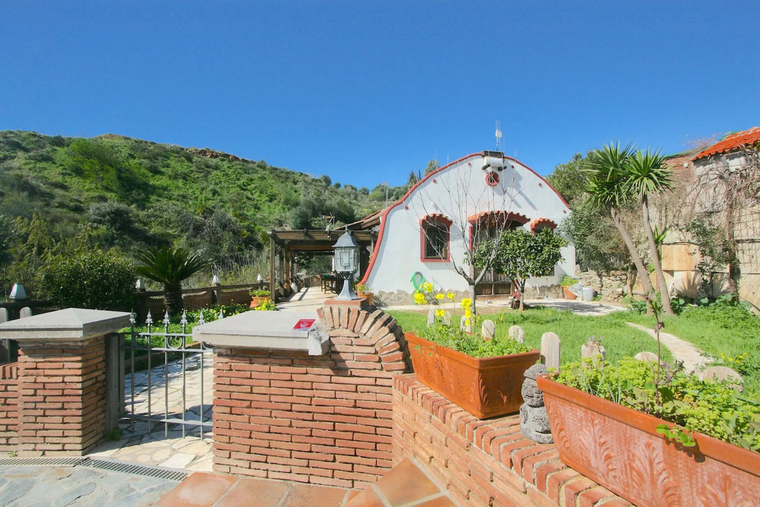 A rare opportunity to own a truly enchanting estate near the picturesque Mijas Pueblo. Set on an expansive 16,000 m² plot, this gated property offers breathtaking panoramic views surrounded by fruit trees, almond trees, and olive groves, creating a peacef