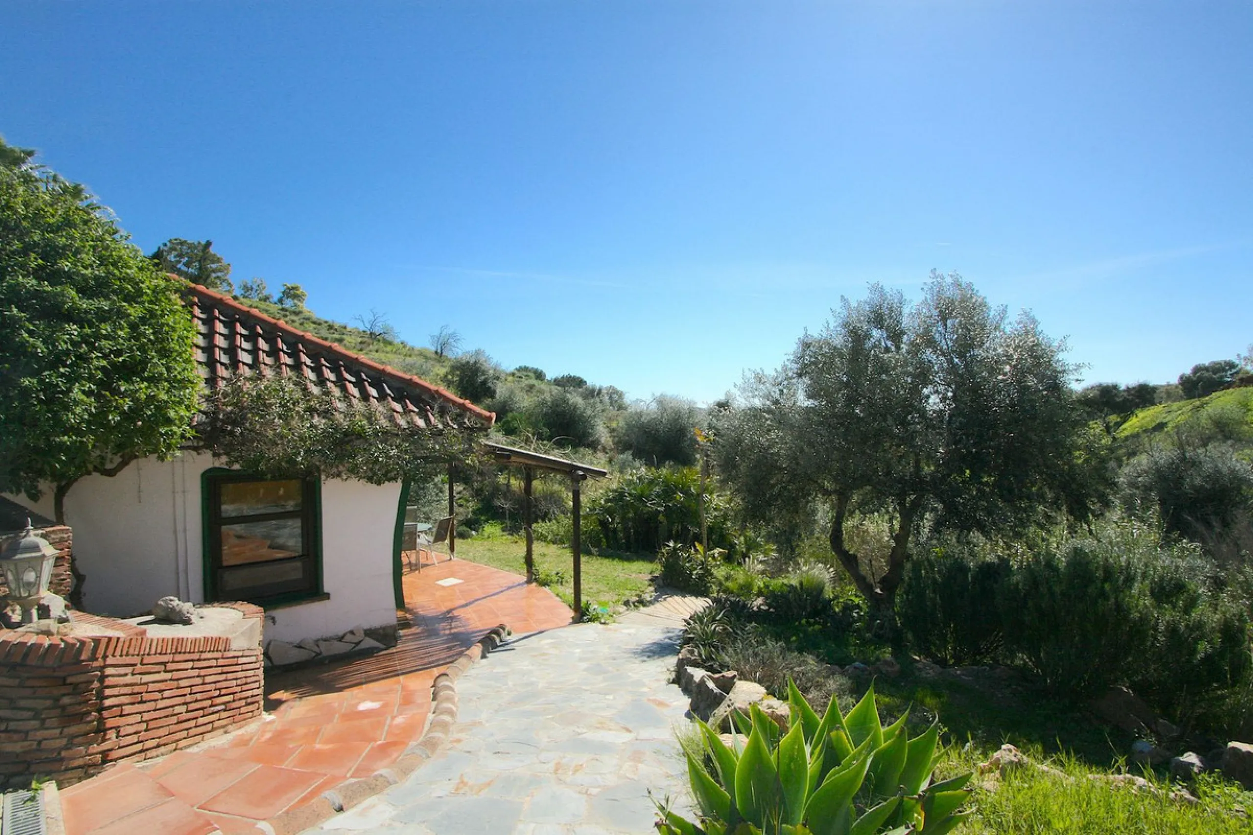 A rare opportunity to own a truly enchanting estate near the picturesque Mijas Pueblo. Set on an expansive 16,000 m² plot, this gated property offers breathtaking panoramic views surrounded by fruit trees, almond trees, and olive groves, creating a peacef