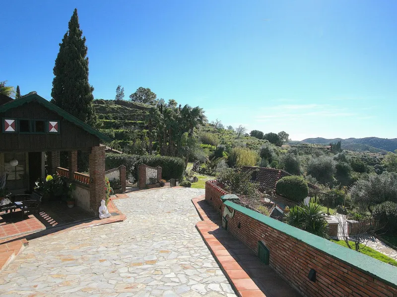 A rare opportunity to own a truly enchanting estate near the picturesque Mijas Pueblo. Set on an expansive 16,000 m² plot, this gated property offers breathtaking panoramic views surrounded by fruit trees, almond trees, and olive groves, creating a peacef