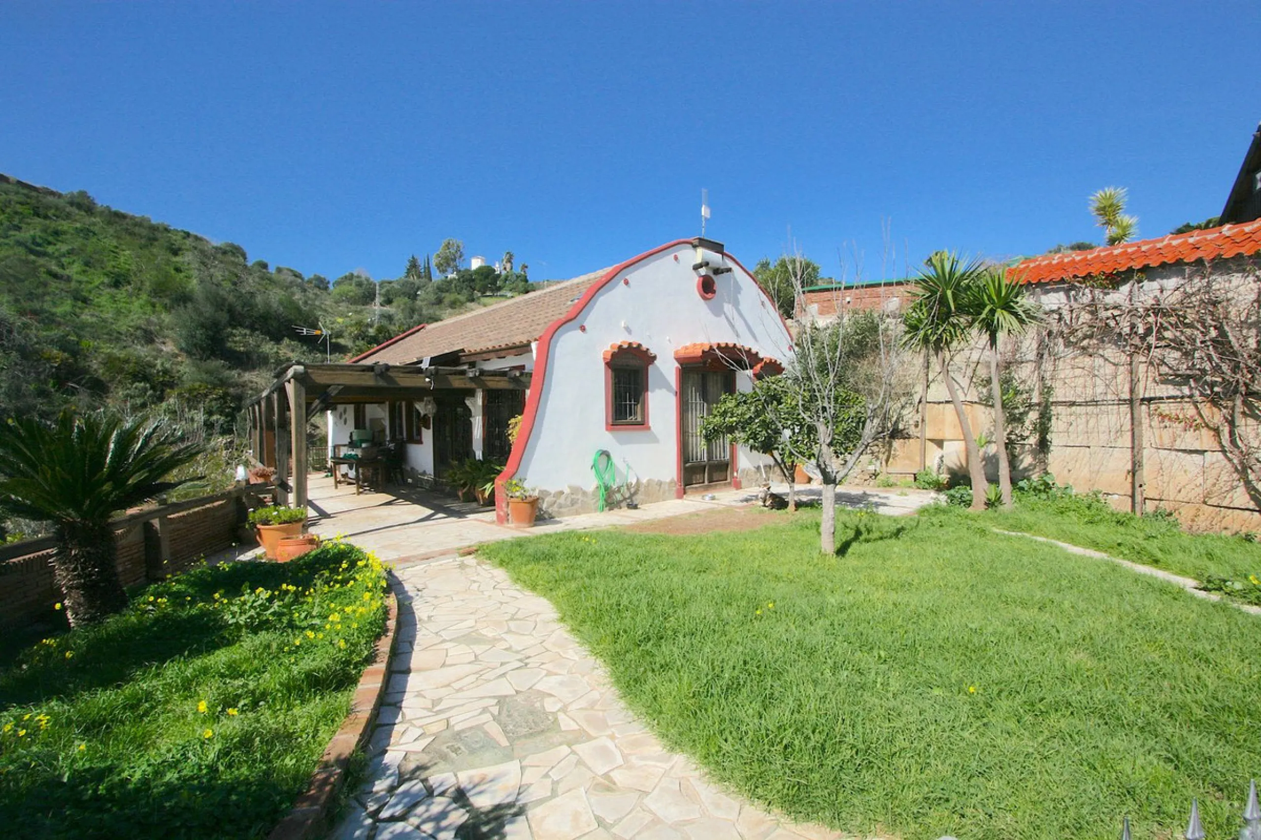 A rare opportunity to own a truly enchanting estate near the picturesque Mijas Pueblo. Set on an expansive 16,000 m² plot, this gated property offers breathtaking panoramic views surrounded by fruit trees, almond trees, and olive groves, creating a peacef