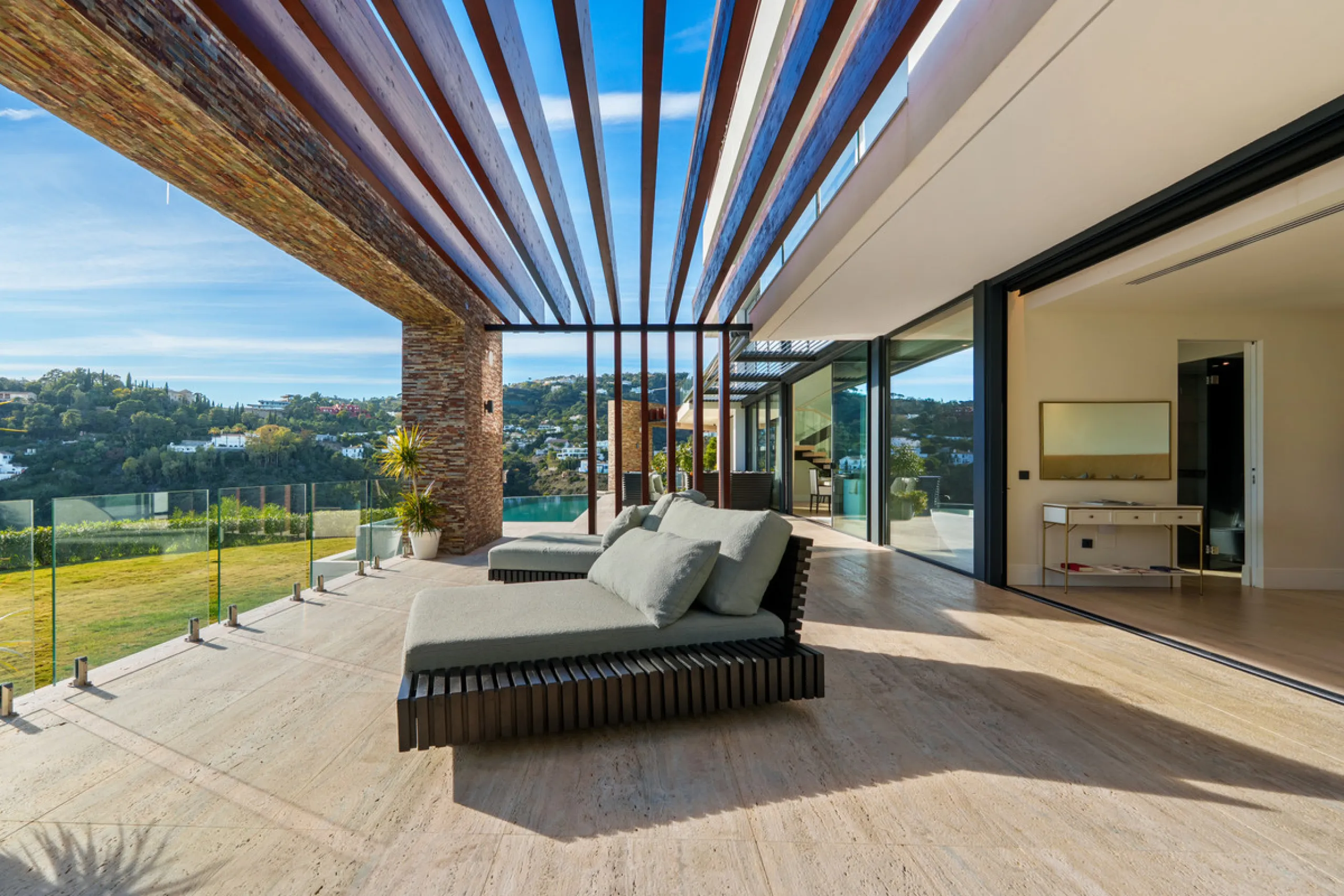 A five-bedroom villa in El Madroñal, Benahavís, offering five bathrooms plus a guest cloakroom, with a first floor dedicated to the master suite with dressing room and library alongside a guest ensuite, a ground floor arranged around formal and informal l