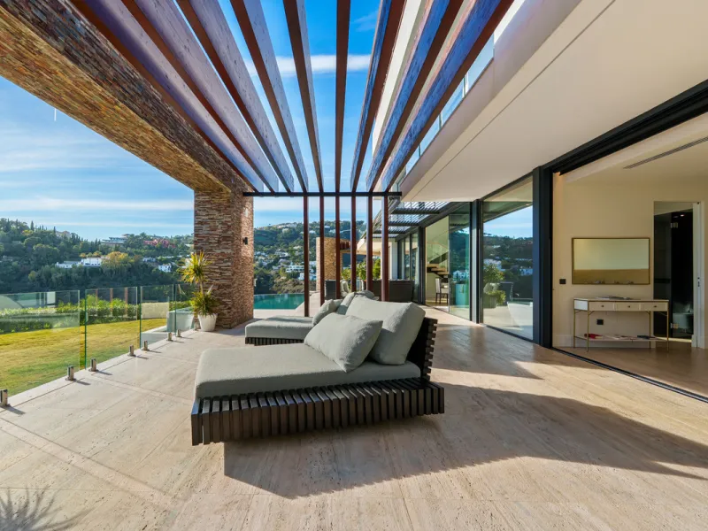 A five-bedroom villa in El Madroñal, Benahavís, offering five bathrooms plus a guest cloakroom, with a first floor dedicated to the master suite with dressing room and library alongside a guest ensuite, a ground floor arranged around formal and informal l