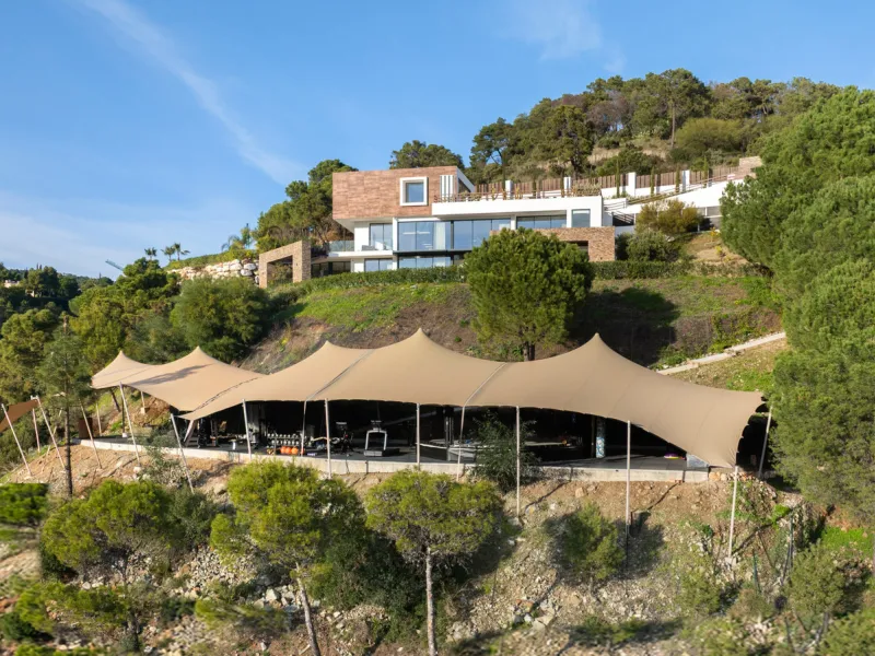 A five-bedroom villa in El Madroñal, Benahavís, offering five bathrooms plus a guest cloakroom, with a first floor dedicated to the master suite with dressing room and library alongside a guest ensuite, a ground floor arranged around formal and informal l