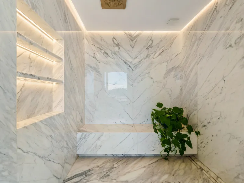A five-bedroom villa in El Madroñal, Benahavís, offering five bathrooms plus a guest cloakroom, with a first floor dedicated to the master suite with dressing room and library alongside a guest ensuite, a ground floor arranged around formal and informal l