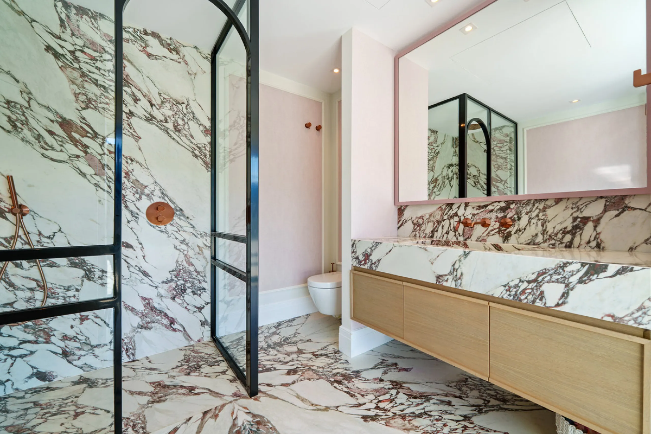 A five-bedroom villa in El Madroñal, Benahavís, offering five bathrooms plus a guest cloakroom, with a first floor dedicated to the master suite with dressing room and library alongside a guest ensuite, a ground floor arranged around formal and informal l