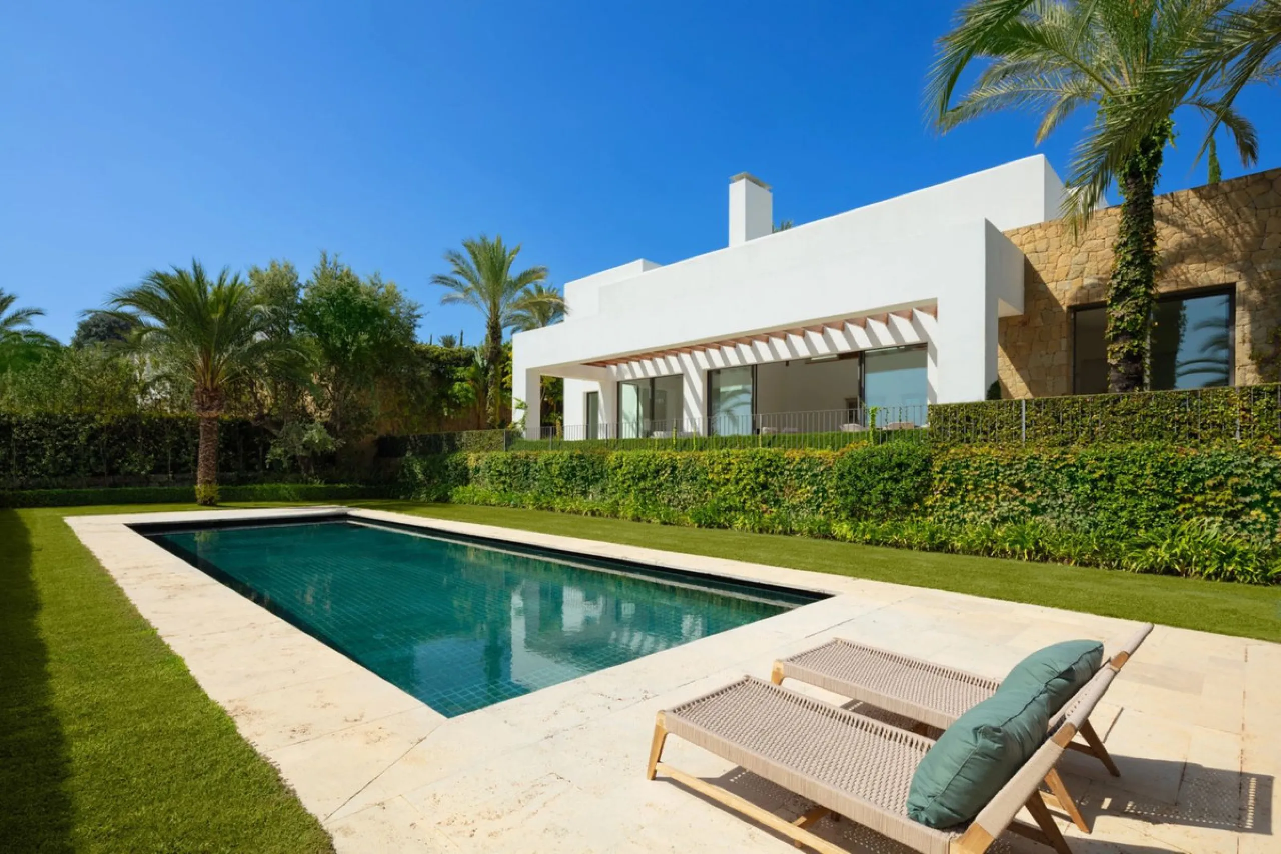 Situated in the exclusive Green 10 enclave within the prestigious Finca Cortesin Resort, this elegant villa offers a modern interpretation of luxury golfside living. Set across two levels, the home features a spacious open-plan living area with soaring ce