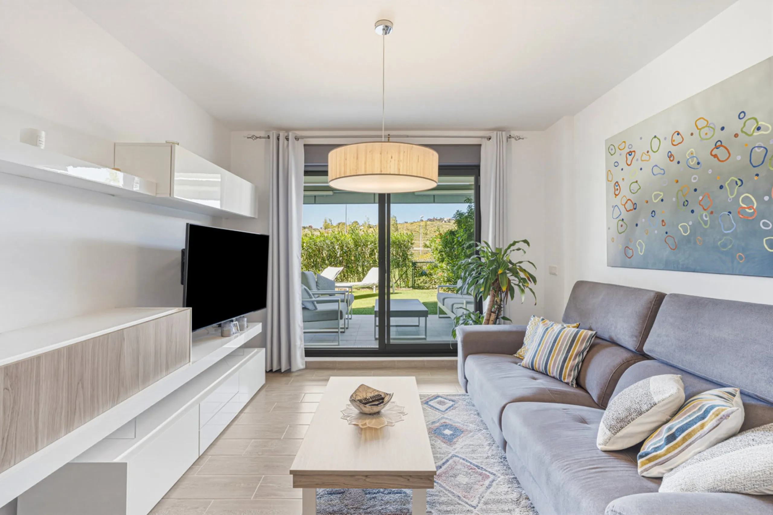This bright and spacious two-bedroom ground floor apartment is ideally located within the sought-after gated community of El Lagar in La Cala de Mijas. Both bedrooms enjoy direct access to a generous terrace and private garden, offering plenty of natural 